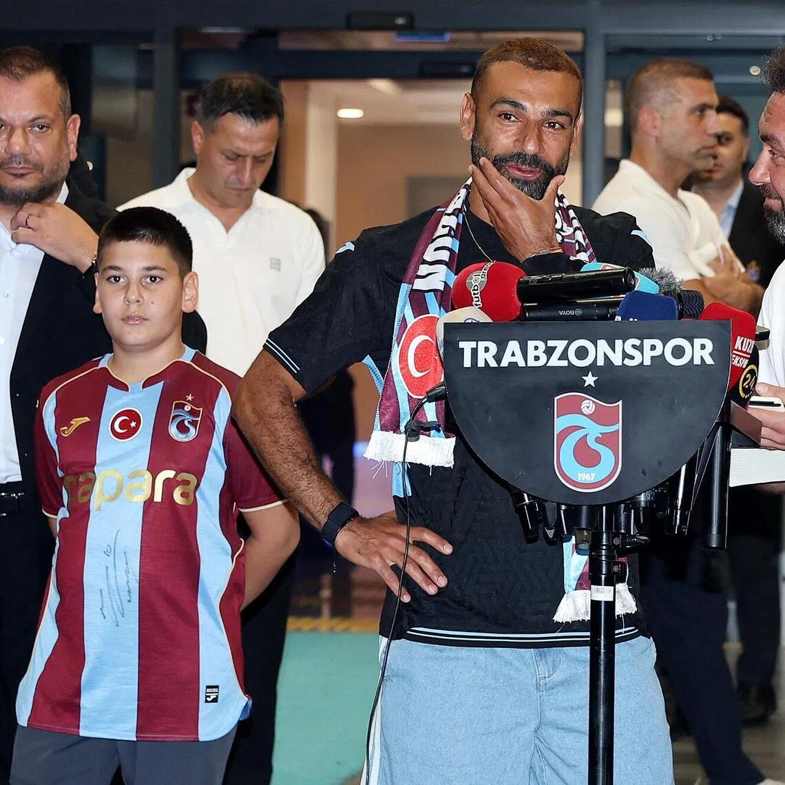 Mohamed Salah is accompanied by Trabzonspor President Ertugrul Dogan as he arrives in the Black Sea city of Trabzon on Aug 5.