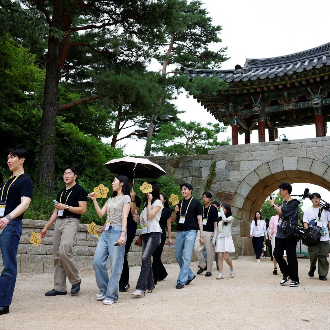 Participants walk through the grounds of Naksansa temple during a Buddhist temple matchmaking programme.