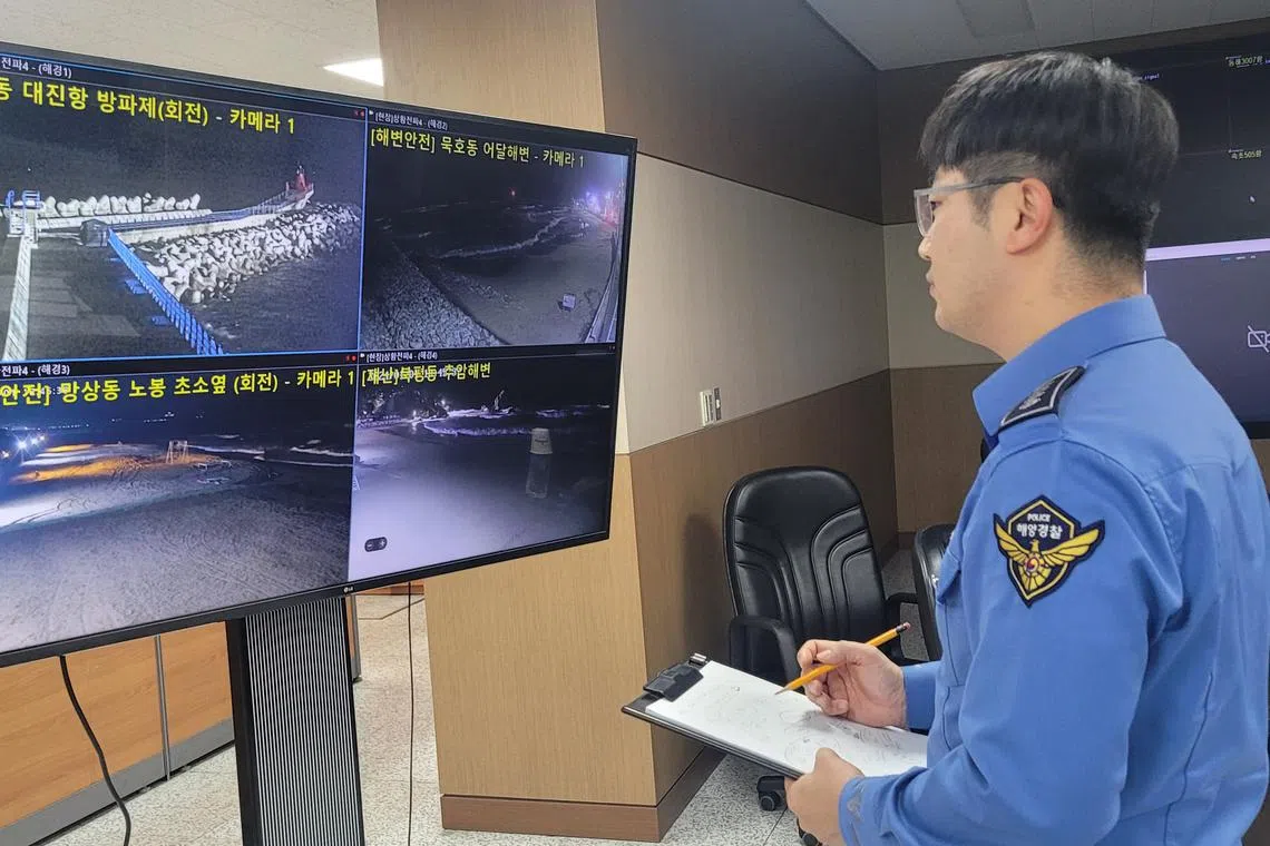 A South Korean Coast Guard officer monitoring CCTV feeds of coastal areas after tsunami warnings were triggered in Japan.