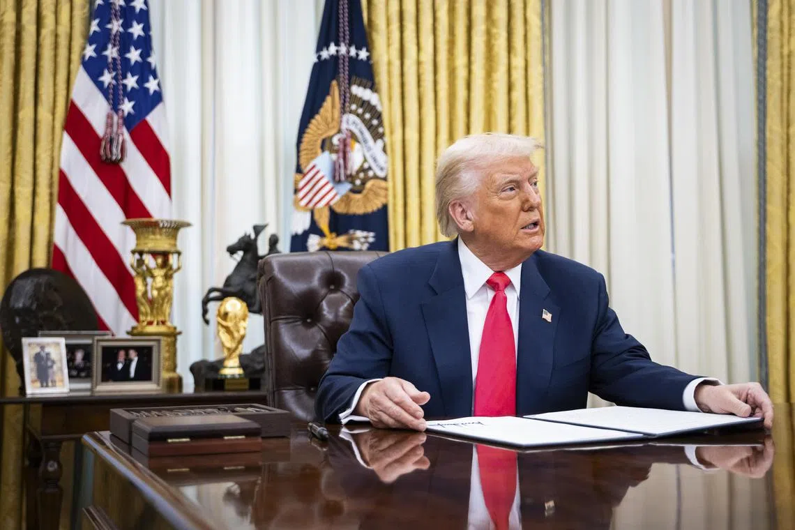 President Donald Trump signing executive orders in the Oval Office of the White House, on March 6.