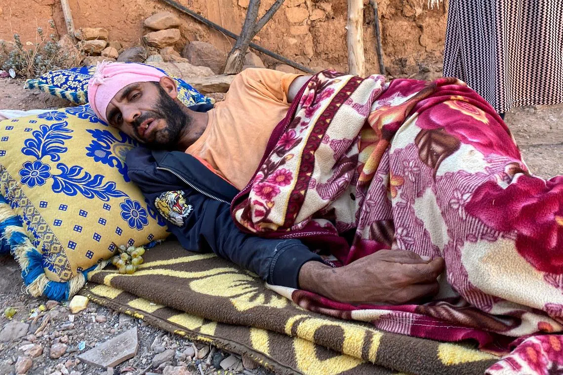 Villager Abdellatif Ait Bella, who was injured in the earthquake that destroyed his home. prepares to spend a second night in the open with wife Saida Bodchich.