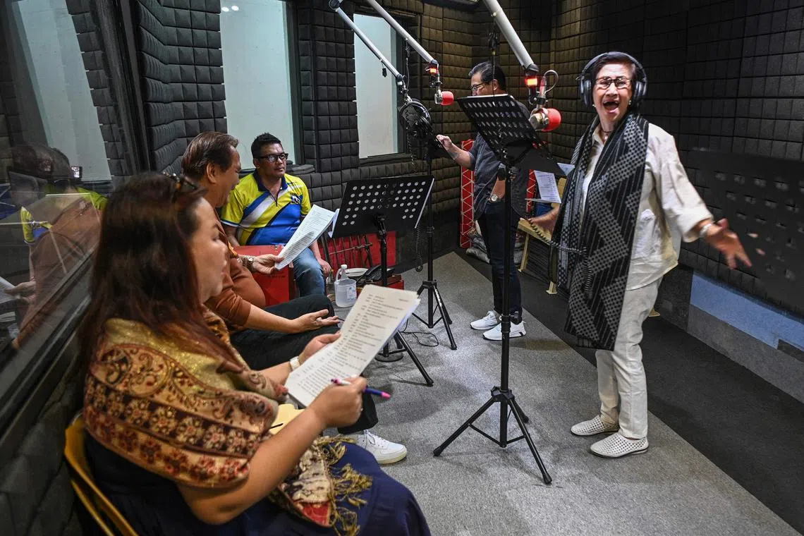 Voice actors recording their part for a radio drama at a studio of a radio station in Manila. 
