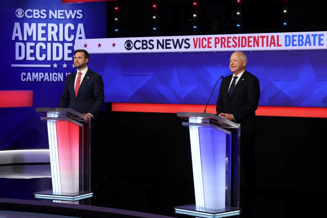Democratic vice presidential nominee Tim Walz (right) and Republican vice presidential nominee JD Vance attend a debate hosted by CBS in New York.
