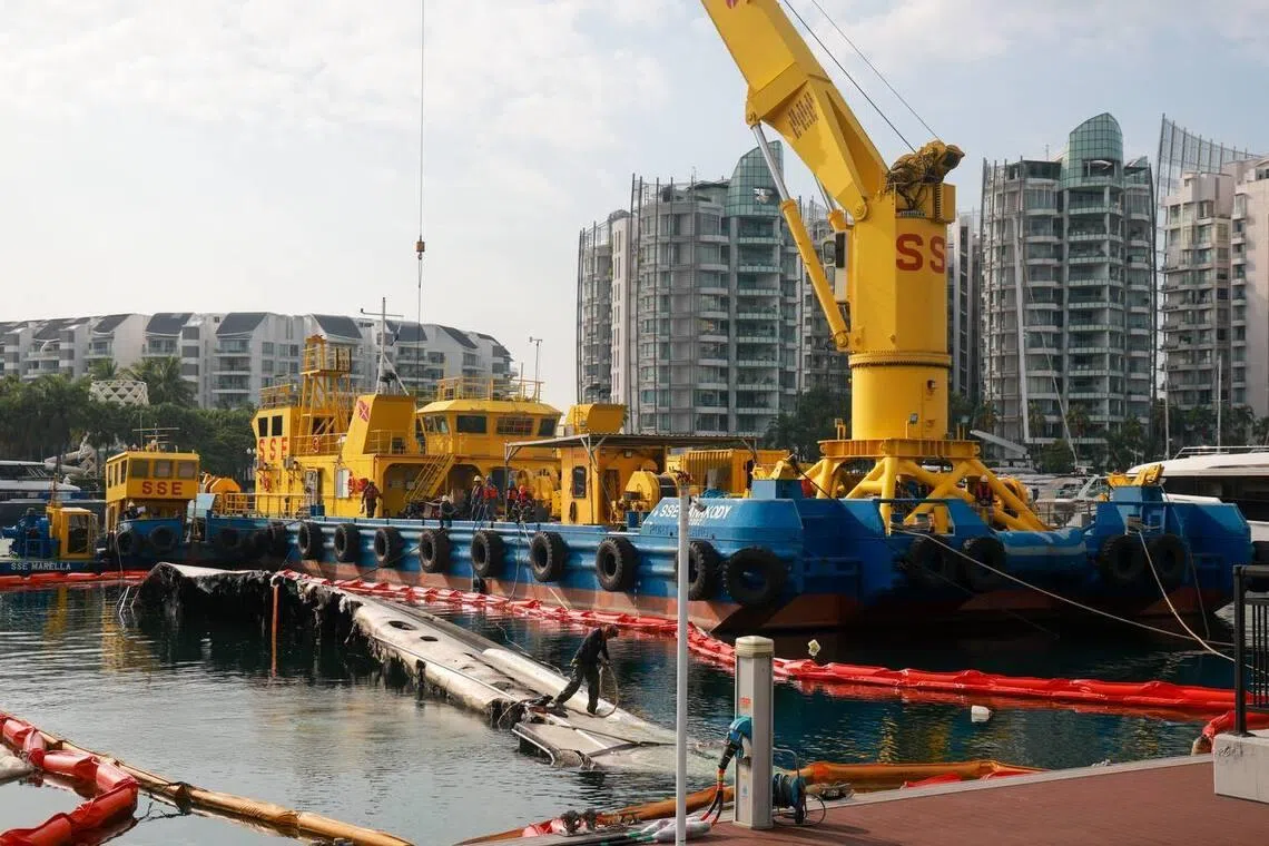 Salvage operations to remove the remains of a yacht which caught fire in June, at ONE°15 Marina Sentosa Cove on July 10.