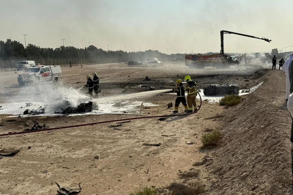 Firefighters working at the site of the Tejas crash at the Dubai Airshow on Nov 21.
