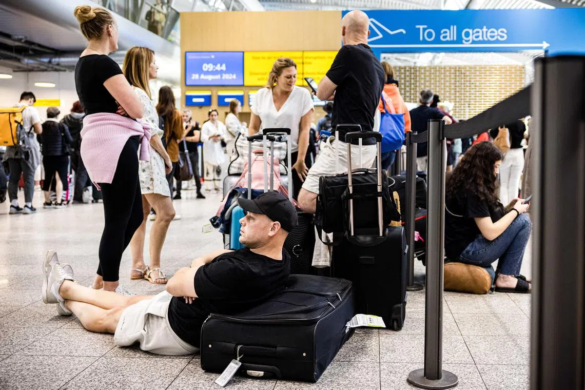 Travellers waiting amid halted flights at Eindhoven Airport, in the Netherlands, on Aug 28.