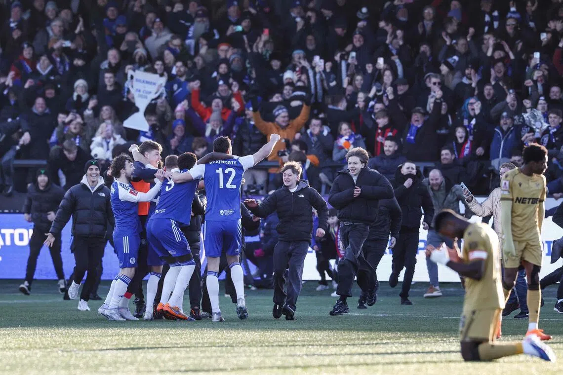 Macclesfield supporters storming the pitch to celebrate the team's 2-1 victory over holders Crystal Palace in the FA Cup third round football match at Leasing.com Stadium on Jan 10, 2026. 