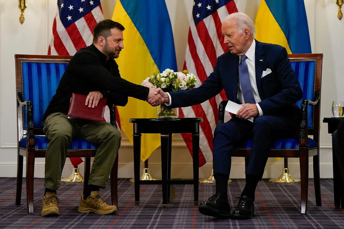 U.S. President Joe Biden shakes hands with Ukrainian President Volodymyr Zelenskiy in Paris, France, June 7, 2024. REUTERS/Elizabeth Frantz