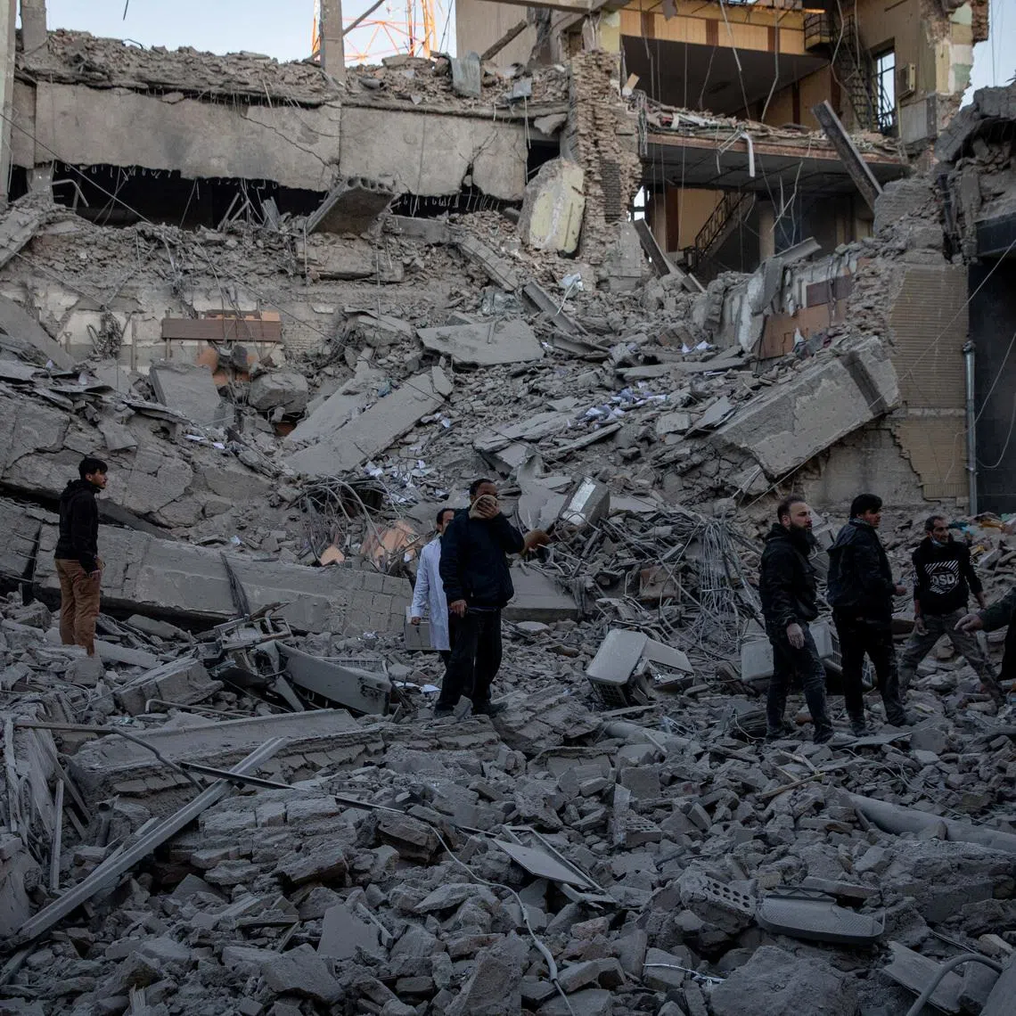 People stand in rubble at the site of an Israel and U.S. strike on a police station in Tehran, Iran, March 3, 2026. Majid Khahi/ISNA/WANA (West Asia News Agency) via REUTERS