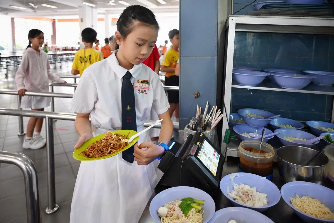 Pei Chun Public School pupil Megan Han, 10, paying for her food at her school canteen using her POSB Smart Buddy watch.