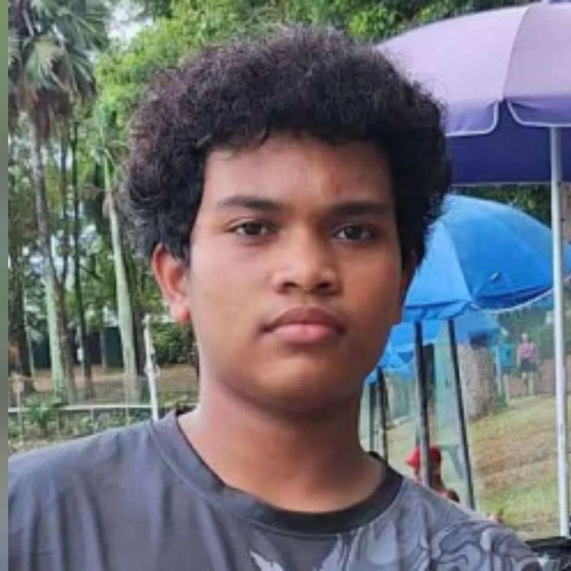 Rayyan Muhammad Faizal was seen wearing a blue shirt and shorts, riding a green bicycle.