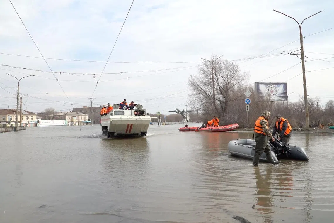 Rescuers ride on and an amphibious vehicle along a flooded street of Orsk, Russia April 9, 2024, in this still image taken from video. REUTERS TV via REUTERS