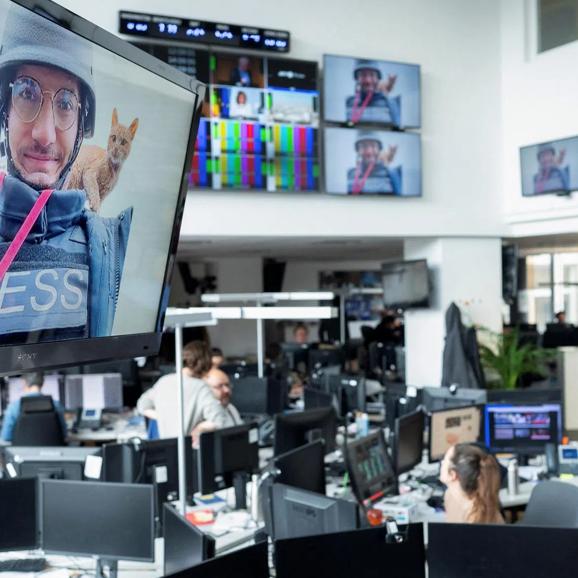 A tribute for journalist Arman Soldin is displayed on screens during a minute's silence held for him at AFP's headquarters in Paris.