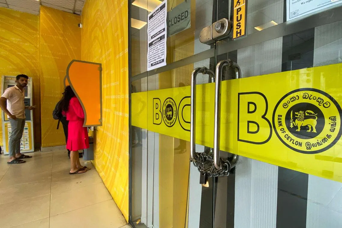 A main branch of the state-owned Bank of Ceylon (BOC) is seen padlocked and shut in Colombo on March 1, 2023 amid a strike staged to defy a ban on strikes and protest high taxes and tariffs. (Photo by ISHARA S. KODIKARA / AFP)