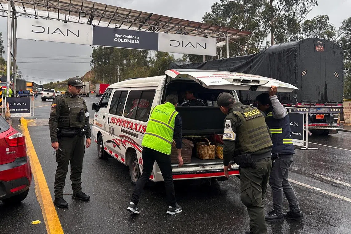 FILE PHOTO: Colombian National Tax and Customs Directorate (DIAN) inspectors and Colombian police officers inspect a vehicle at the Rumichaca International Bridge, in this file photo, in Ipiales, Colombia January 22, 2026. REUTERS/Camila Leon/File Photo