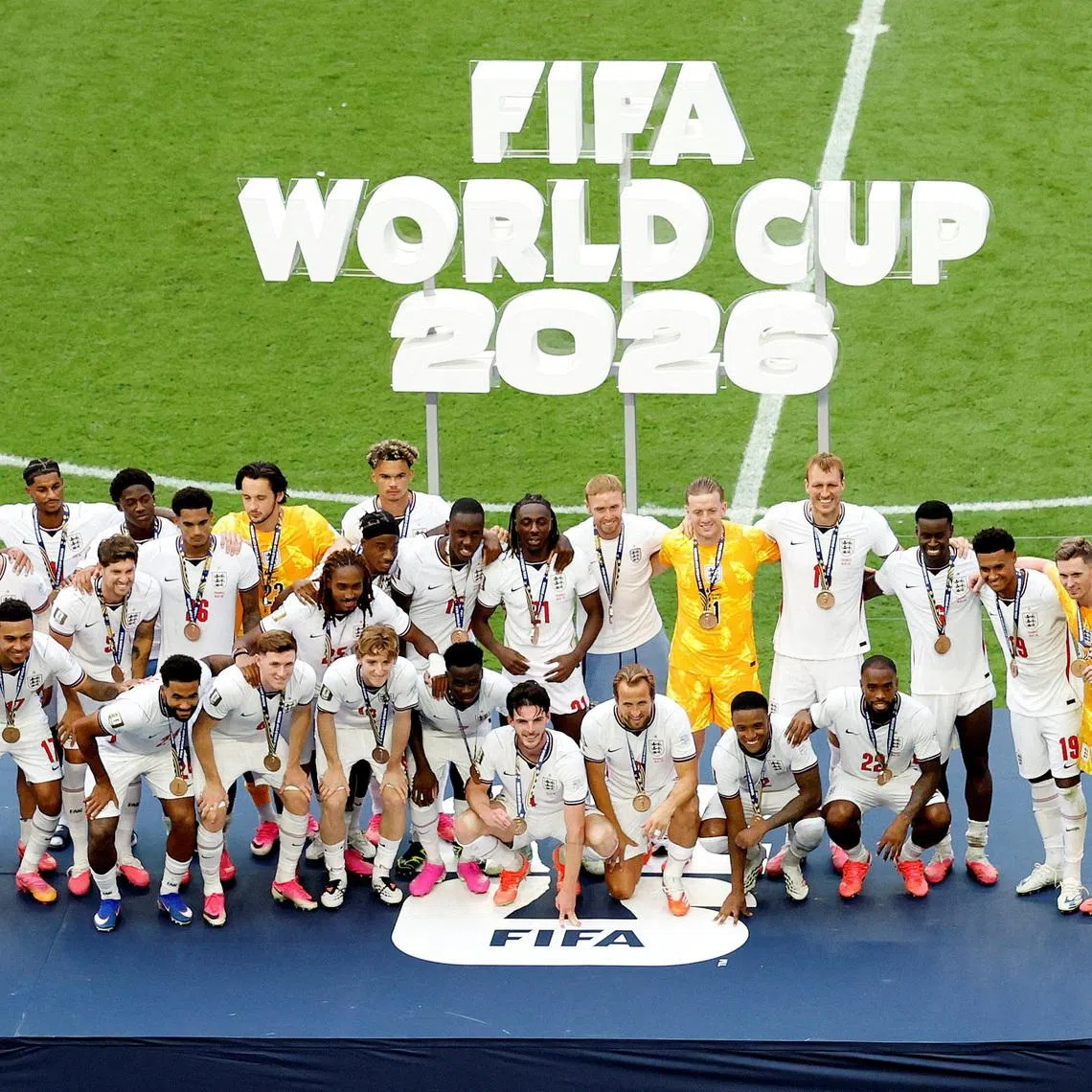 Soccer Football - FIFA World Cup 2026 - Bronze Final - France v England - Miami Stadium, Miami Gardens, Florida, U.S. - July 18, 2026 England manager Thomas Tuchel and England players wear their bronze medals as they pose for a picture on the podium during the ceremony after the match REUTERS/Marco Bello