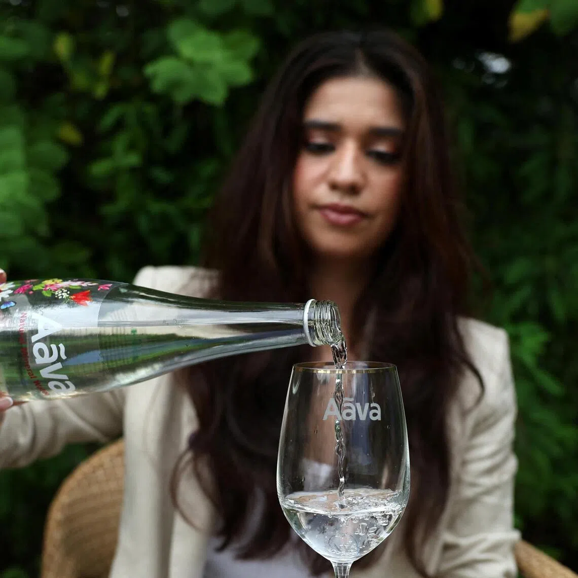 Avanti Mehta, 32, India's youngest water sommelier, fills a glass with Aava Natural mineral water in Ahmedabad, India.