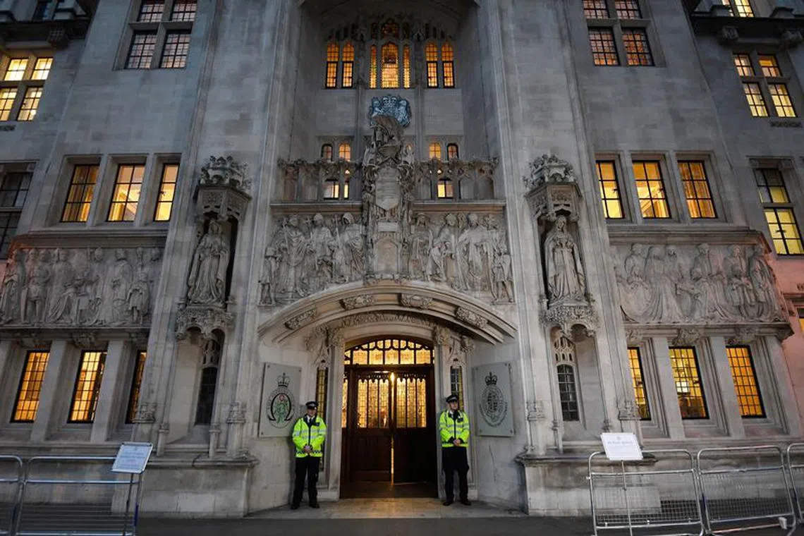 FILE PHOTO: Police officers stand on duty outside the Supreme Court in Parliament Square, central London, Britain December 6, 2016. REUTERS/Toby Melville/File Photo