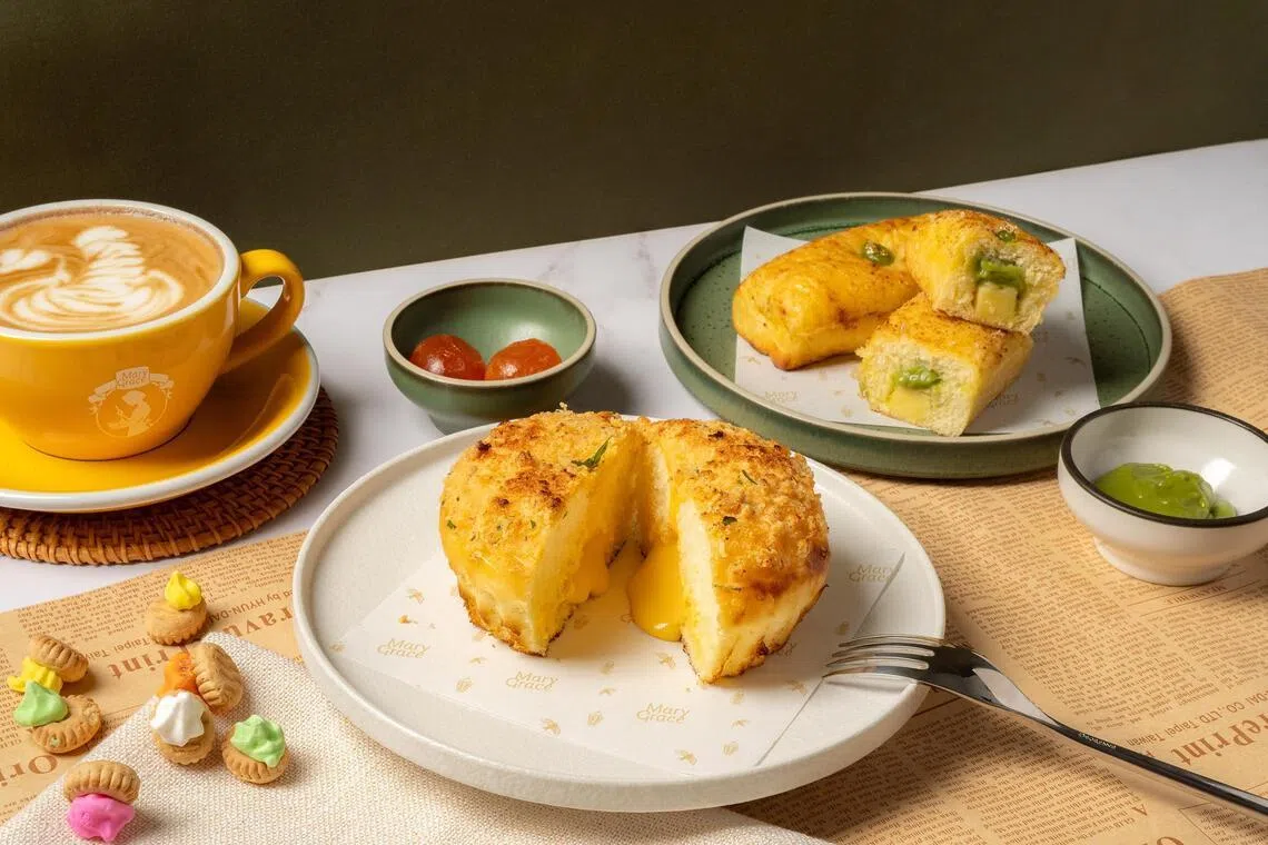 Singapore-exclusive creations of Salted Egg Ensaymada (foreground) and Kaya Pandan Cheese Roll. 
