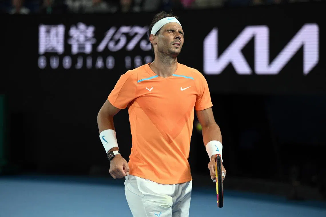 Nadal grimaces in pain during his match against Mackenzie McDonald at the Australian Open.