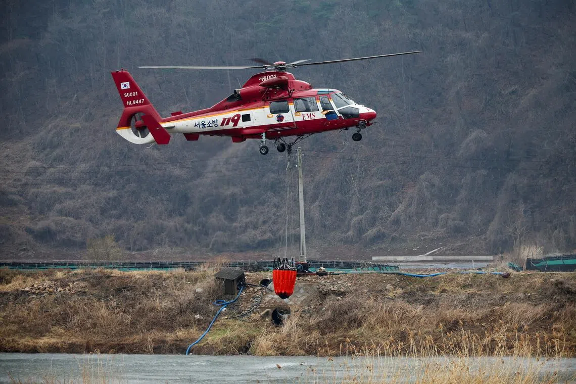 Firefighting operations continue as a wildfire burns in Yeongyang, south-eastern South Korea, on March 28.
