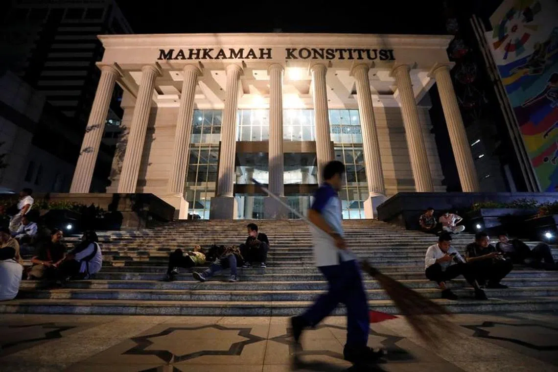 A cleaning worker walks outside Indonesia's constitutional court in Jakarta, Indonesia, May 24, 2019. REUTERS/Willy Kurniawan/File Photo