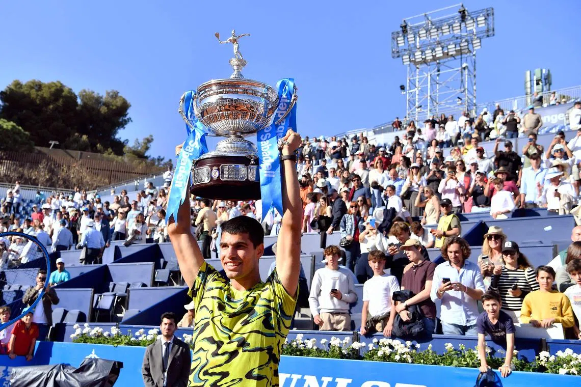 Spain's Carlos Alcaraz raises his trophy after beating Greece's Stefanos Tsitsipas during the ATP Barcelona Open.