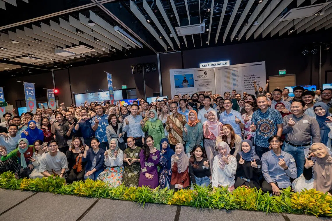 President Halimah Yacob (standing, in green), flanked by Minister for Social and Family Development Masagos Zulkifli (on her left) and Senior Minister of State for Defence and Manpower Zaqy Mohamad, at the Masyarakat Gemilang Conference on July 8.