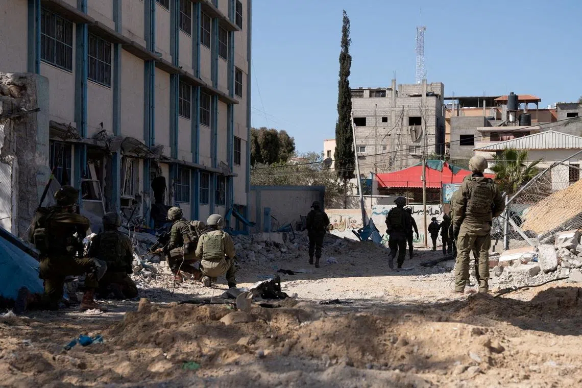 Israeli soldiers operate in a location given as Nasser Hospital in Gaza.