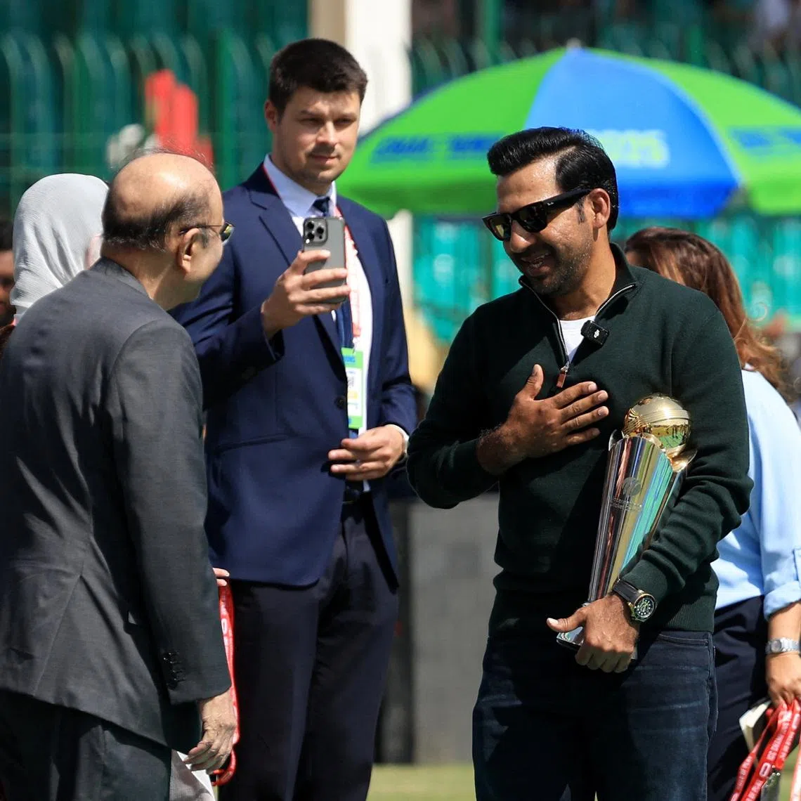 Cricket - ICC Men's Champions Trophy - Group A - Pakistan v New Zealand - National Stadium, Karachi, Pakistan - February 19, 2025 Former Pakistan cricketer Sarfaraz Ahmed with the trophy before the match REUTERS/Akhtar Soomro