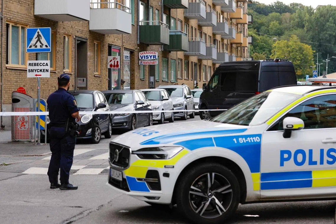(FILES) Police are seen at the site of an explosion in Olskroken in Gothenburg, Sweden, August 31, 2023. Swedish criminal gangs, which are behind a surge of bombings and shootings in the country in recent years, are using fake Spotify streams to launder money, a Swedish newspaper reported on September 5, 2023. (Photo by Adam IHSE / TT News Agency / AFP) / Sweden OUT