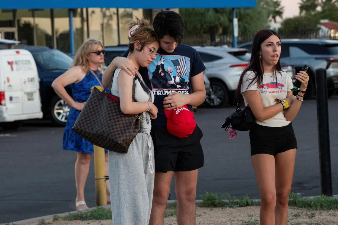 People react as they gather outside the mortuary where the body of slain conservative activist Charlie Kirk was delivered, in Phoenix, Arizona, U.S., September 11, 2025, one day after Kirk was fatally shot during an event at Utah Valley University. REUTERS/Thomas Machowicz