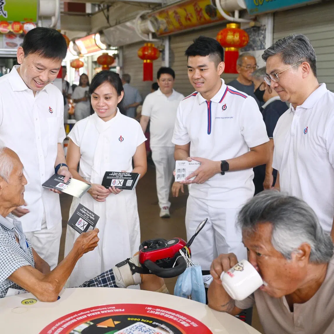PAP Toa Payoh-Bishan GRC candidates (standing, from left) Chee Hong Tat, Elysa Chen, Cai Yinzhou, and Saktiandi Supaat, during a walkabout at Toa Payoh Lor 7 market on April 26, 2025. 
