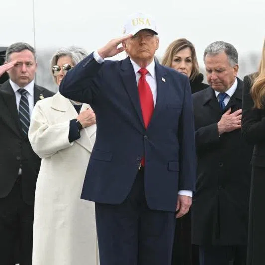 US Special Envoy Steve Witkoff stands behind President Donald Trump and first lady Melania Trump during a dignified transfer of the remains of six US Army service members.