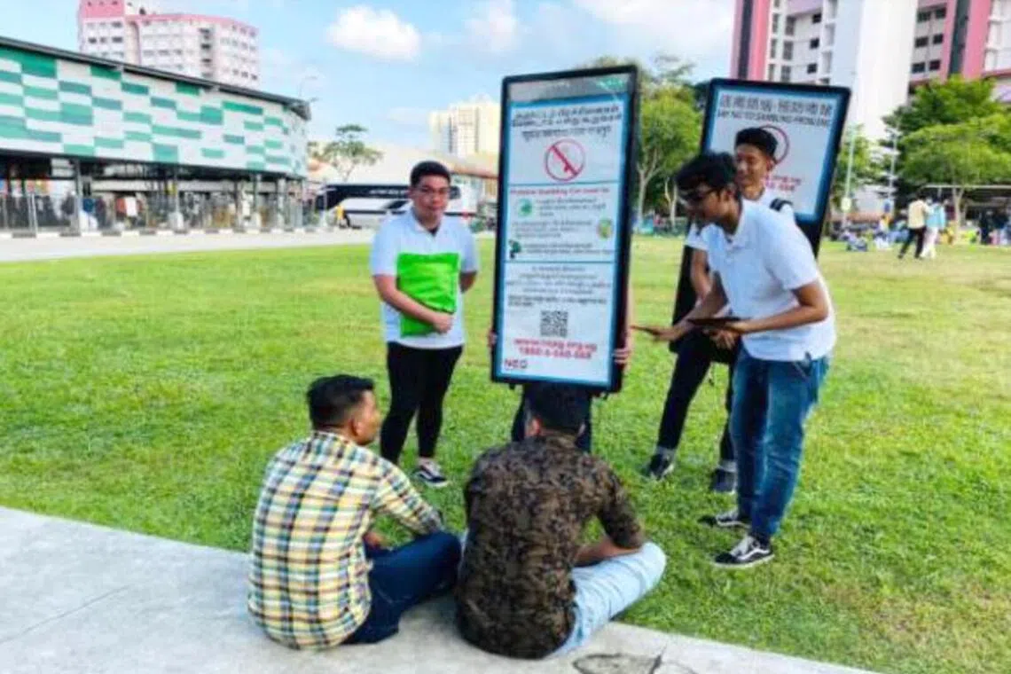 Poster walkers at places frequent by migrant workers.