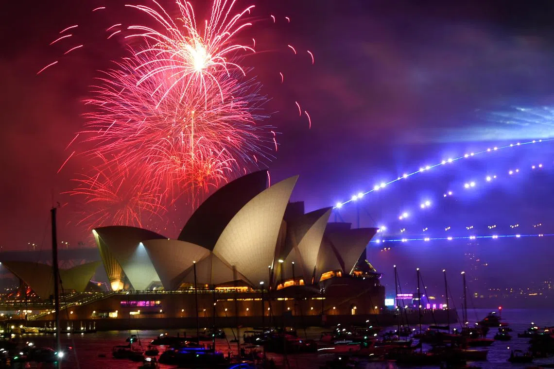 Early fireworks explode over Sydney Opera House during the New Year's Eve celebrations, in Sydney, Australia, Dec 31, 2022. 
