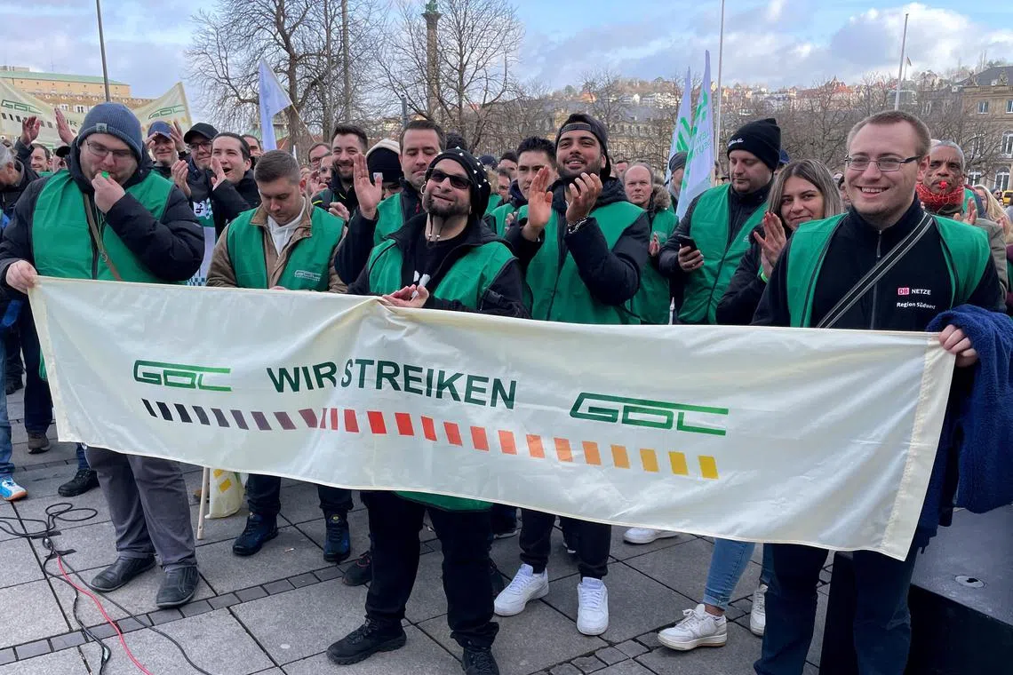 German train driver's union (GDL) supporters hold a banner with the slogan "we are on strike" during a demonstration demanding wage increases and a shorter working week, in Stuttgrt, Germany, January 25, 2024. REUTERS/Ayhan Uyanik