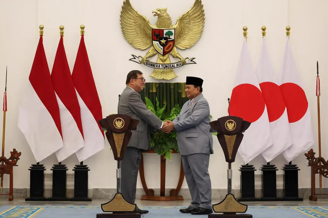 Japan's Prime Minister Shigeru Ishiba (left) and Indonesian President Prabowo Subianto shake hands during a press conference at the Presidential Palace in Bogor, Indonesia.