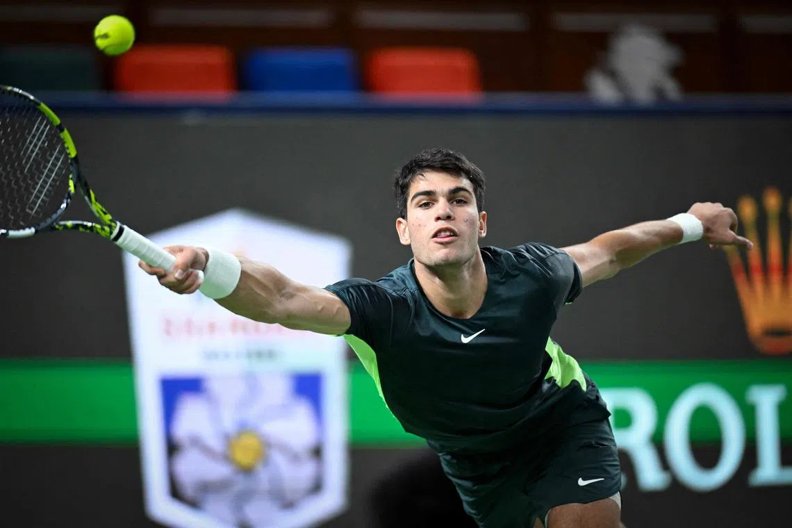Spain's Carlos Alcaraz hits a return to Bulgaria's Grigor Dimitrov during their men's singles match at the Shanghai Masters.