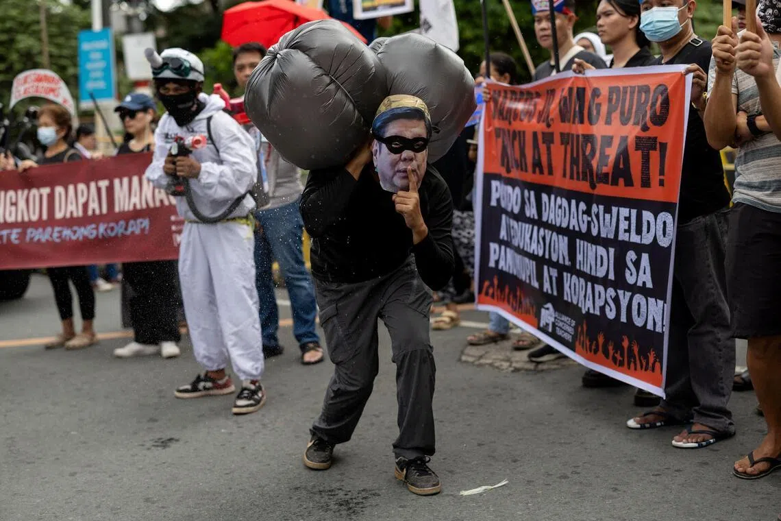 An activist posing in a costume depicting Philippine President Ferdinand Marcos Jr as a robber during a protest against government corruption in Manila, Philippines, on Oct 31, 2025.