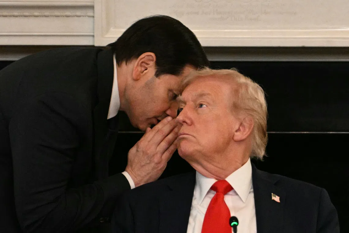 US Secretary of State Marco Rubio whispers in the ear of President Donald Trump during a roundtable about Antifa in the State Dining Room of the White House in Washington, DC, on Oct 8.