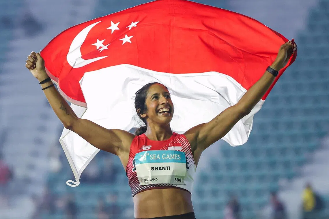 Shanti Pereira celebrating with the national flag after winning the women’s 100m final. Her two gold medals are among three secured by Singapore’s track and field athletes at the Dec 9-20 SEA Games in Thailand.