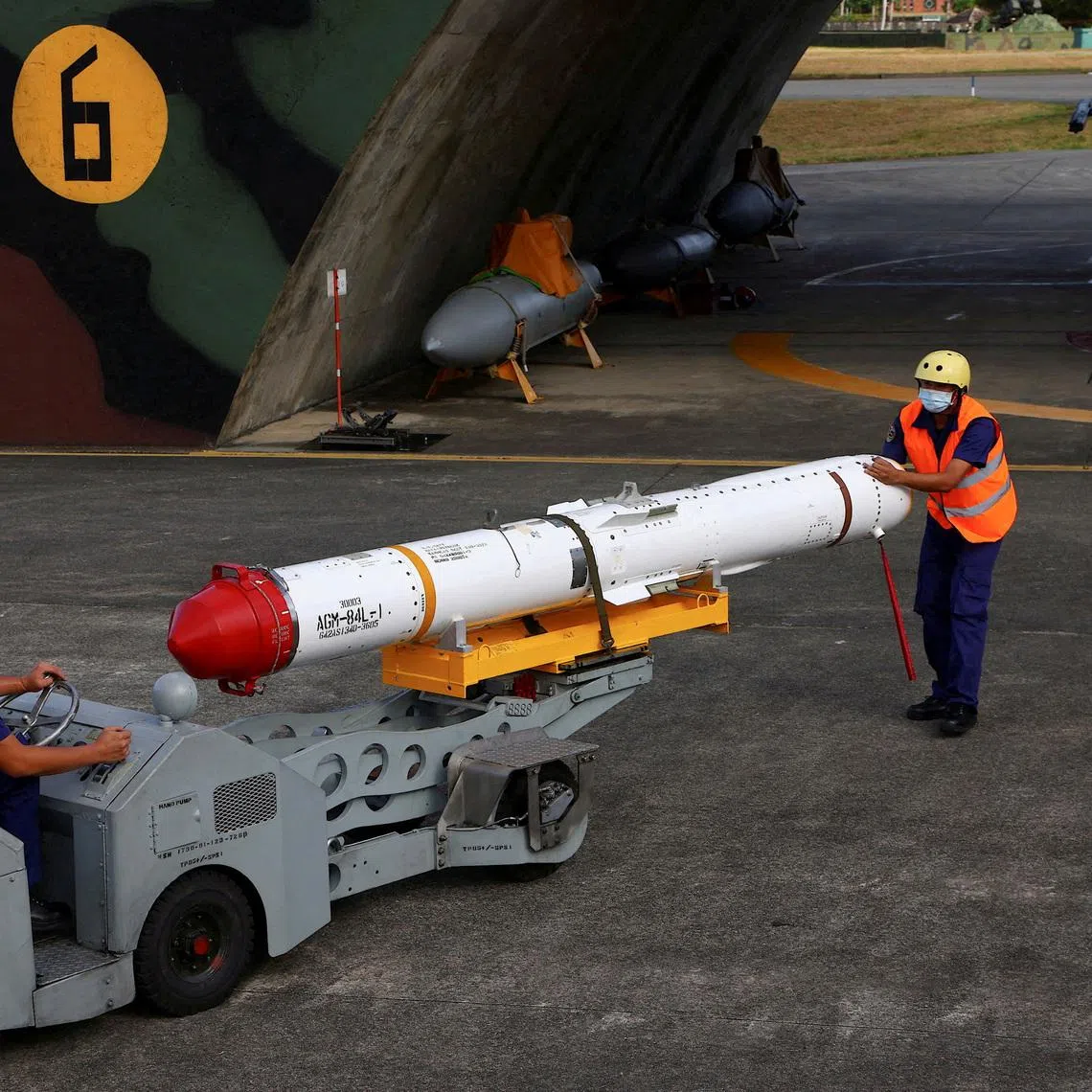 Air force soldiers load US-made Harpoon AGM-84 anti-ship missile at a combat readiness mission at the airbase in Hualien.