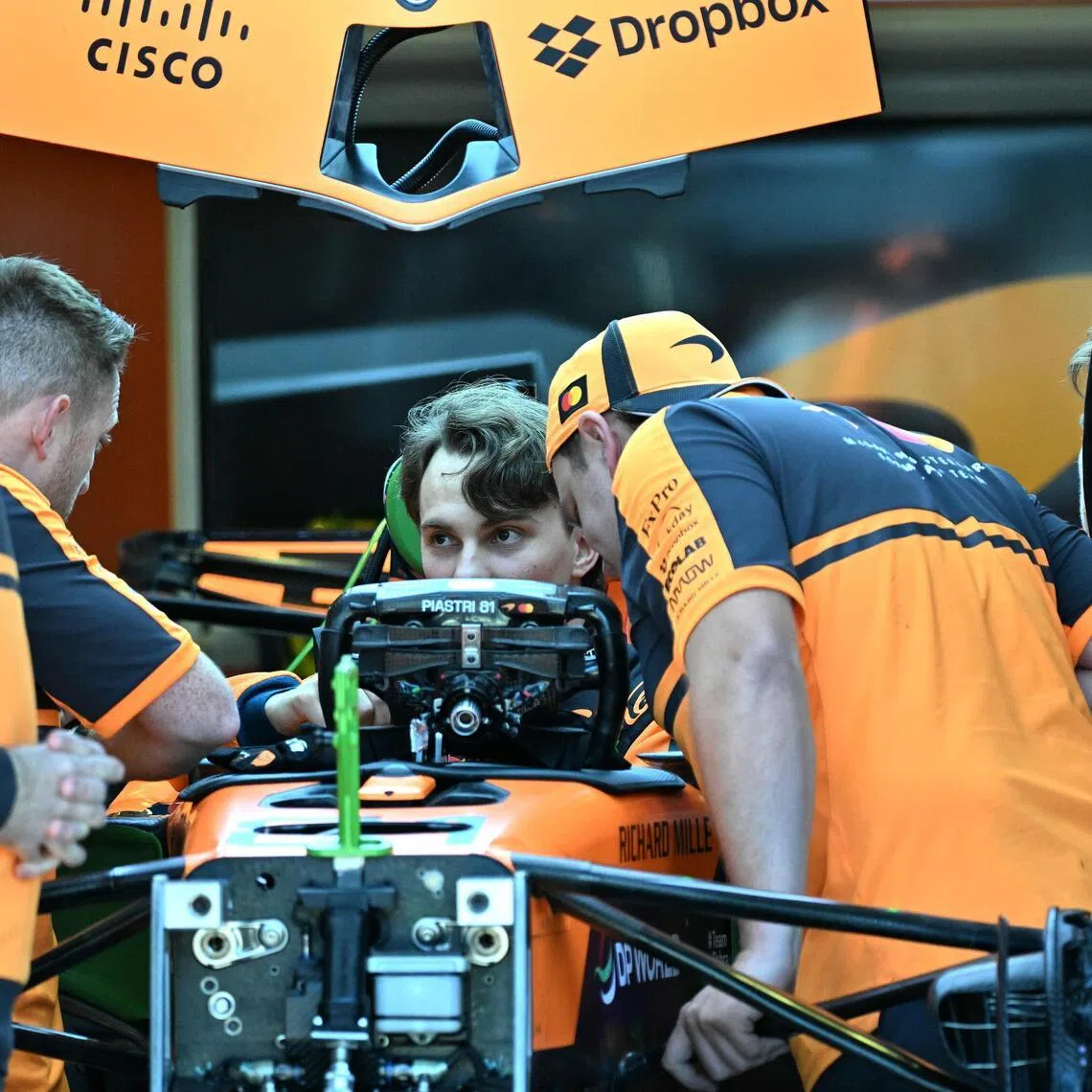 McLaren's Australian driver Oscar Piastri inspects his car with team mechanics in the garage ahead of the Australian Grand Prix at Melbourne’s Albert Park on March 5.
