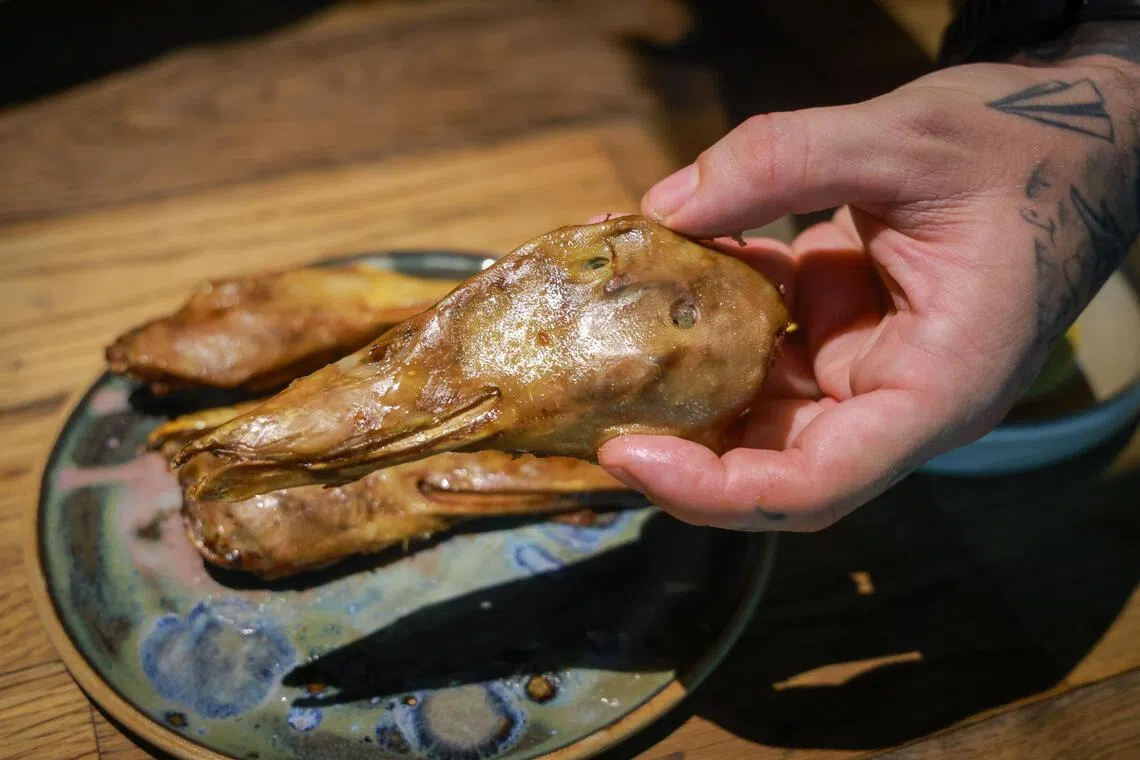 Chef Peter Smit of Dirty Supper pictured holding a duck head.
