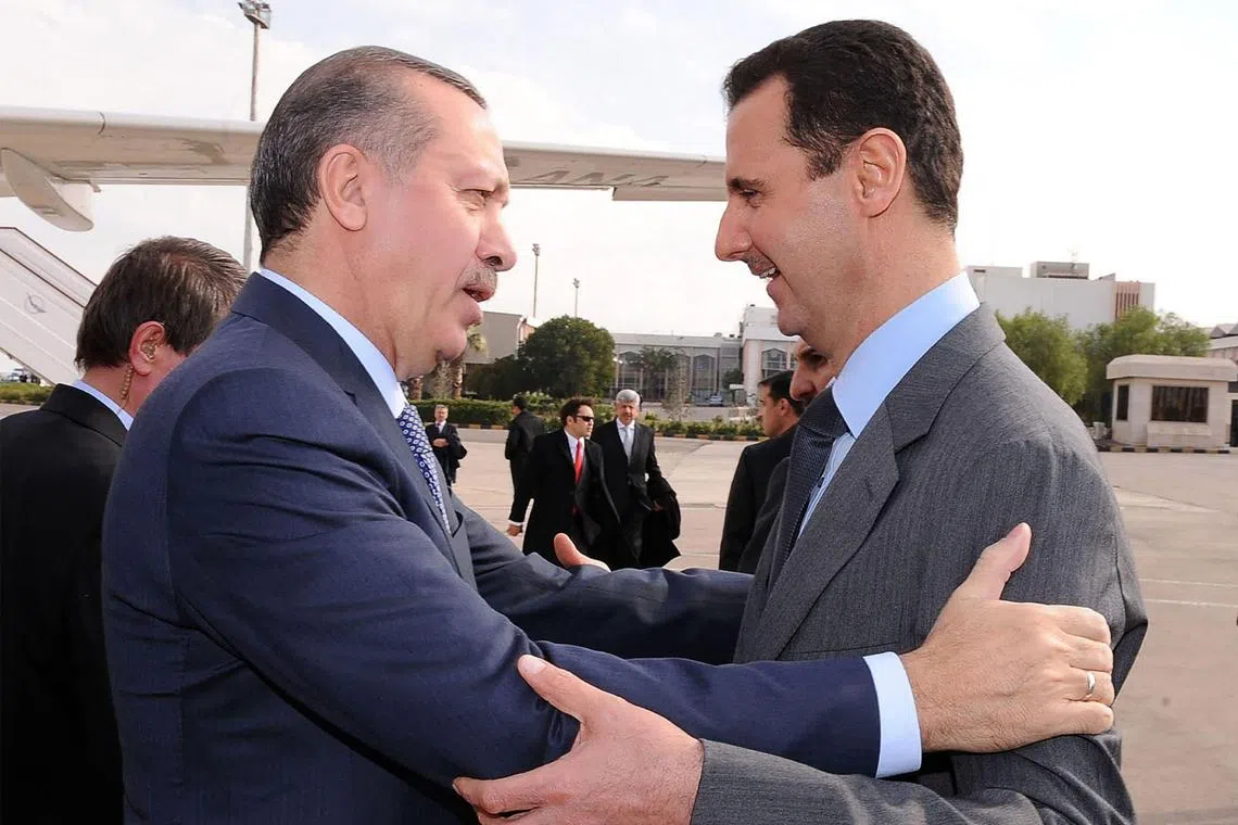 In a photo taken on January 2011, then Syrian President Bashar al-Assad (right) welcomes Turkish President Recep Tayyip Erdogan at Damascus airport.