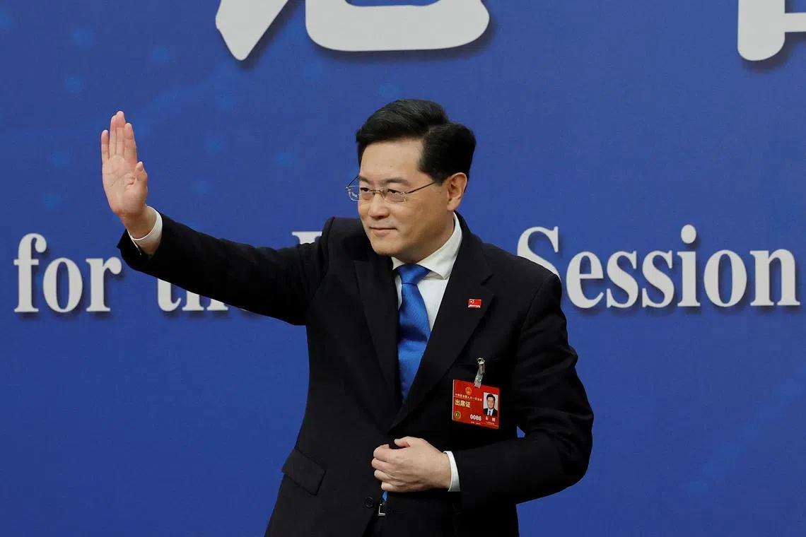 Chinese Foreign Minister Qin Gang waves at the end of a news conference on the sidelines of the National People's Congress (NPC) in Beijing, China March 7, 2023. REUTERS/Thomas Peter