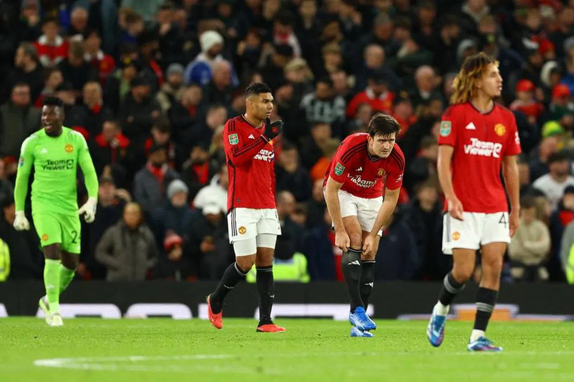 FILE PHOTO: Soccer Football - Carabao Cup - Fourth Round - Manchester United v Newcastle United - Old Trafford, Manchester, Britain - November 1, 2023 Manchester United's Harry Maguire, Casemiro and teammates look dejected after conceding their second goal, scored by Newcastle United's Lewis Hall REUTERS/Molly Darlington NO USE WITH UNAUTHORIZED AUDIO, VIDEO, DATA, FIXTURE LISTS, CLUB/LEAGUE LOGOS OR 'LIVE' SERVICES. ONLINE IN-MATCH USE LIMITED TO 45 IMAGES, NO VIDEO EMULATION. NO USE IN BETTING, GAMES OR SINGLE CLUB/LEAGUE/PLAYER PUBLICATIONS./File Photo