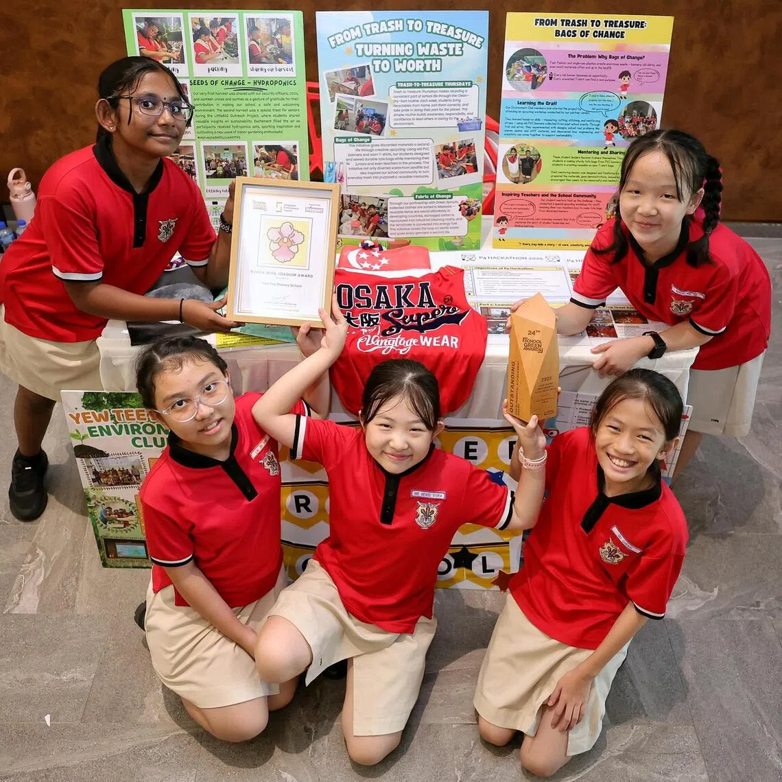 Yew Tee Primary School pupils (from left) Ashmita Ahgilen, Lim Zhi Ning, Vivika Nie, Gu Chenxi and Khoo Ke Qi with their Vanda Miss Joaquim Award and Outstanding Environmental Achievement Award.