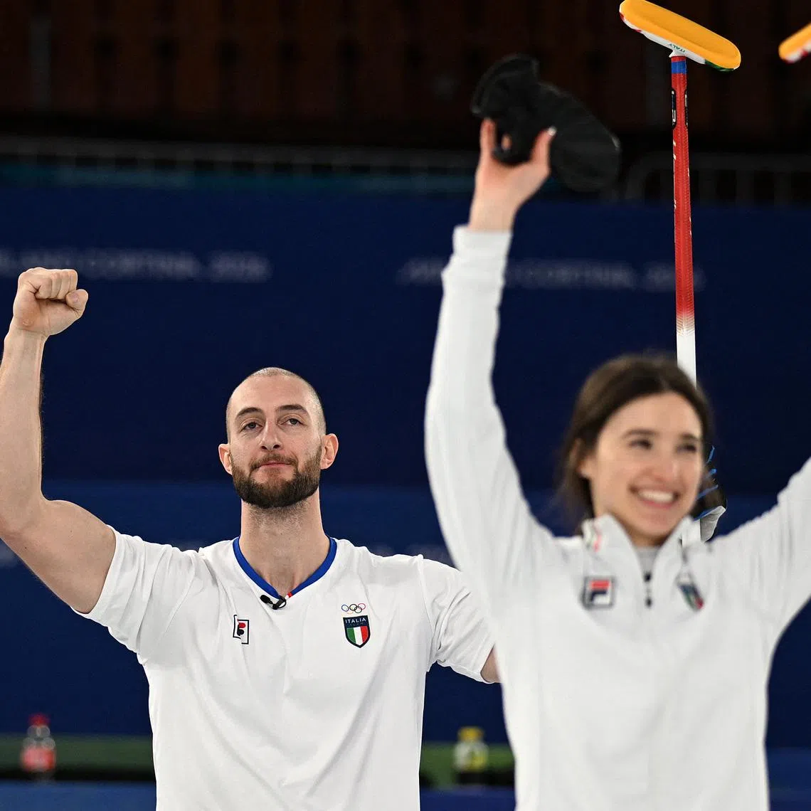 Milano Cortina 2026 Olympics - Curling - Mixed Doubles Bronze Medal Game - Great Britain vs Italy - Cortina Curling Olympic Stadium, Cortina d'Ampezzo, Italy - February 10, 2026. Amos Mosaner of Italy celebrates winning with Stefania Constantini of Italy their bronze medal match against Bruce Mouat of Britain and Jennifer Dodds of Britain REUTERS/Jennifer Lorenzini